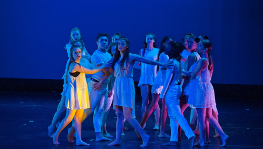 Group of female students performing a dance on stage