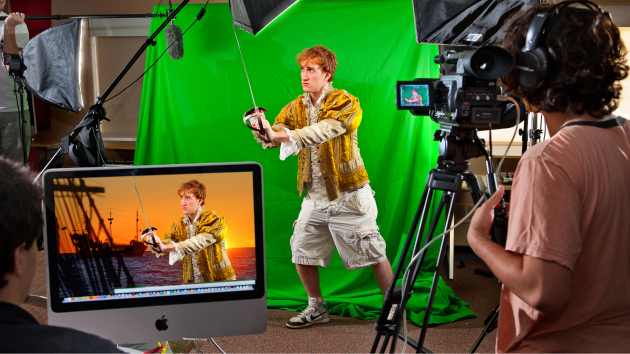 Male actor in front a green screen being filmed