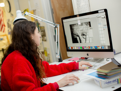Female student editing a photo on the computer