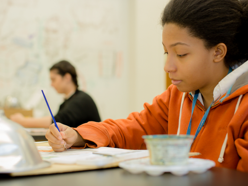 Female student painting in class