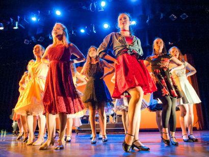 Students dancing in a musical theatre performance on stage