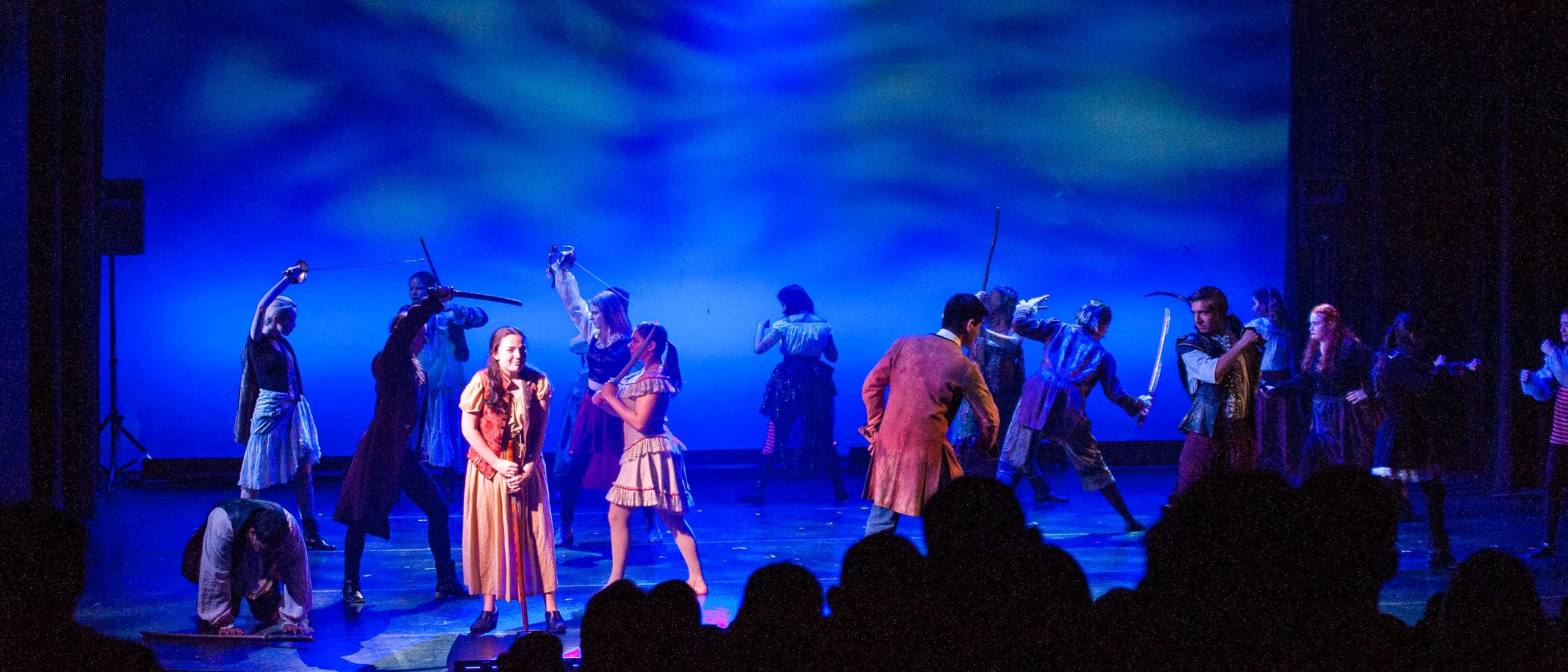 Students dancing with swords during a performance