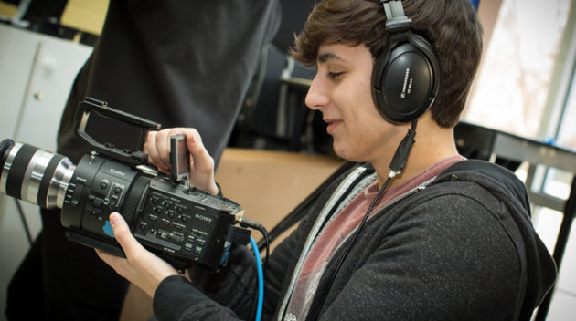 Male student filming something