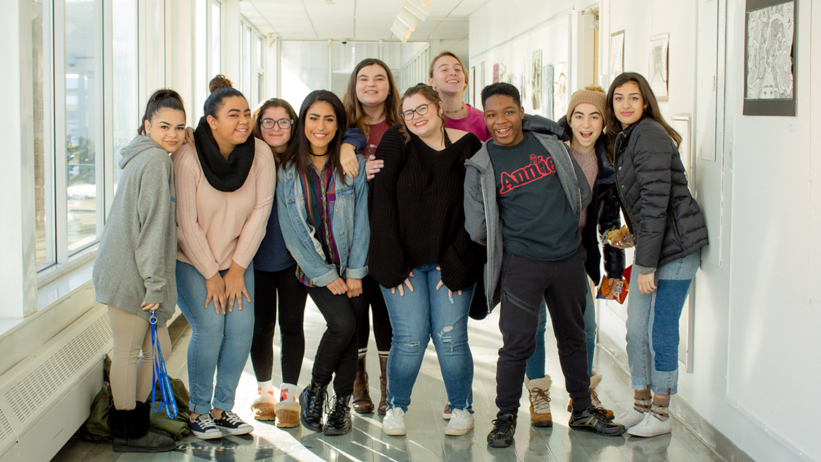 Group of students smiling together in the hallway