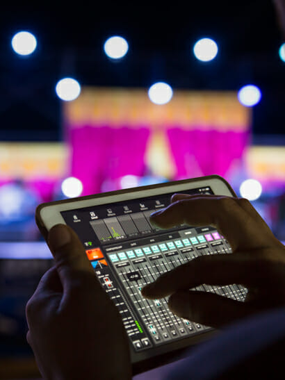 Someone controlling lights via an ipad for the stage