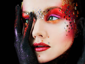 Woman with costume makeup on a jewels on her face