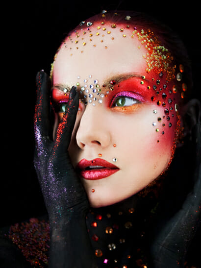 Woman with costume makeup on a jewels on her face