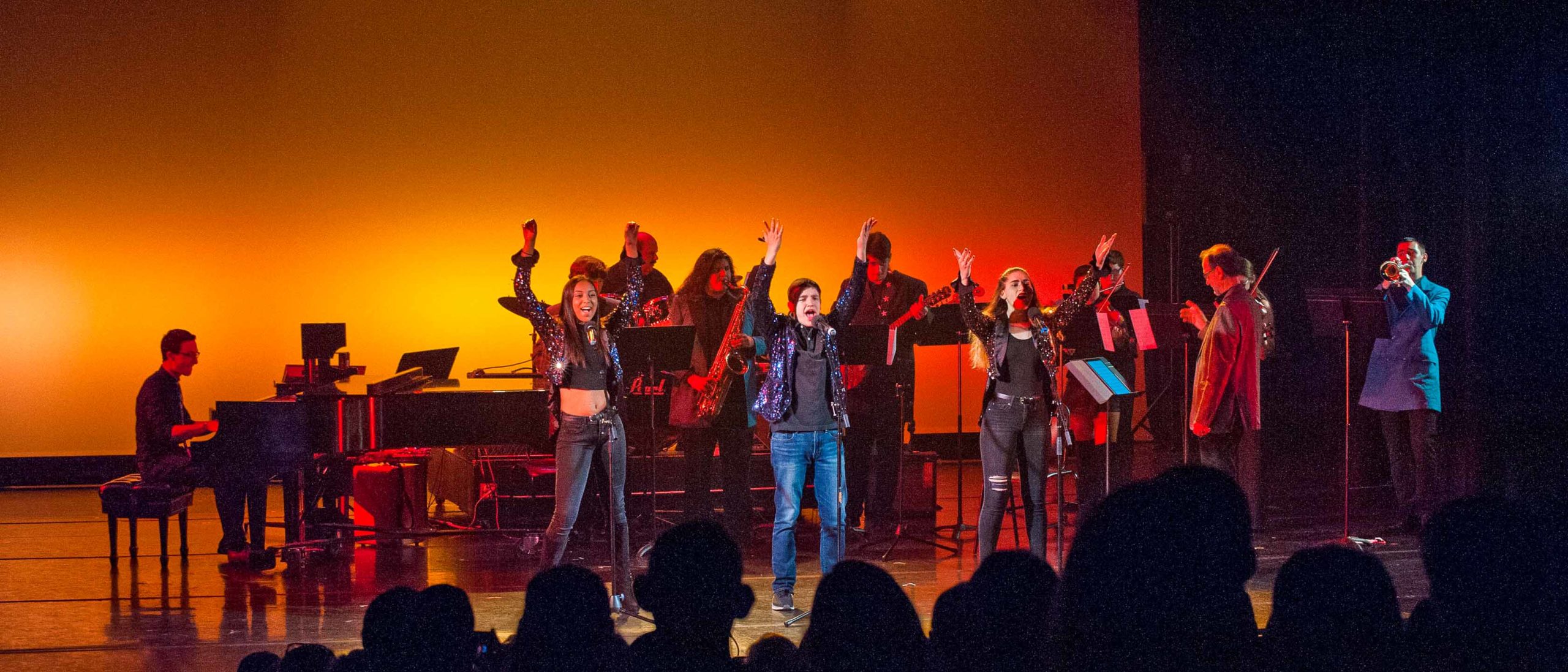 Group of students singing on stage