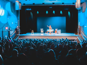 Boy performing on stage in front of a large audience