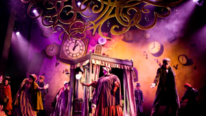 Theatrical production with a large set and many clocks on the walls