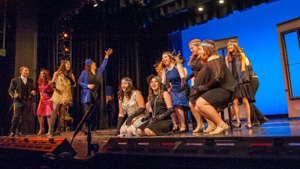 Students in a play production on stage