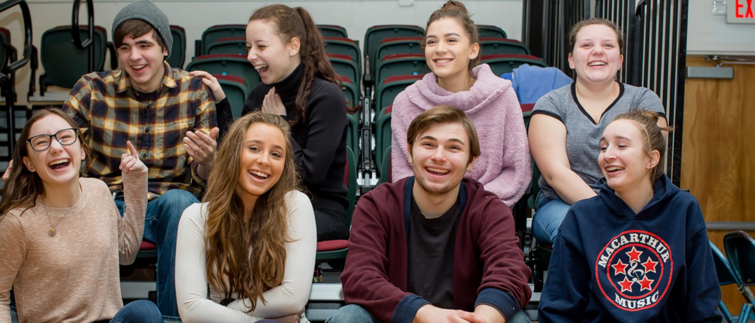 Group of students in class smiling and laughing togehter