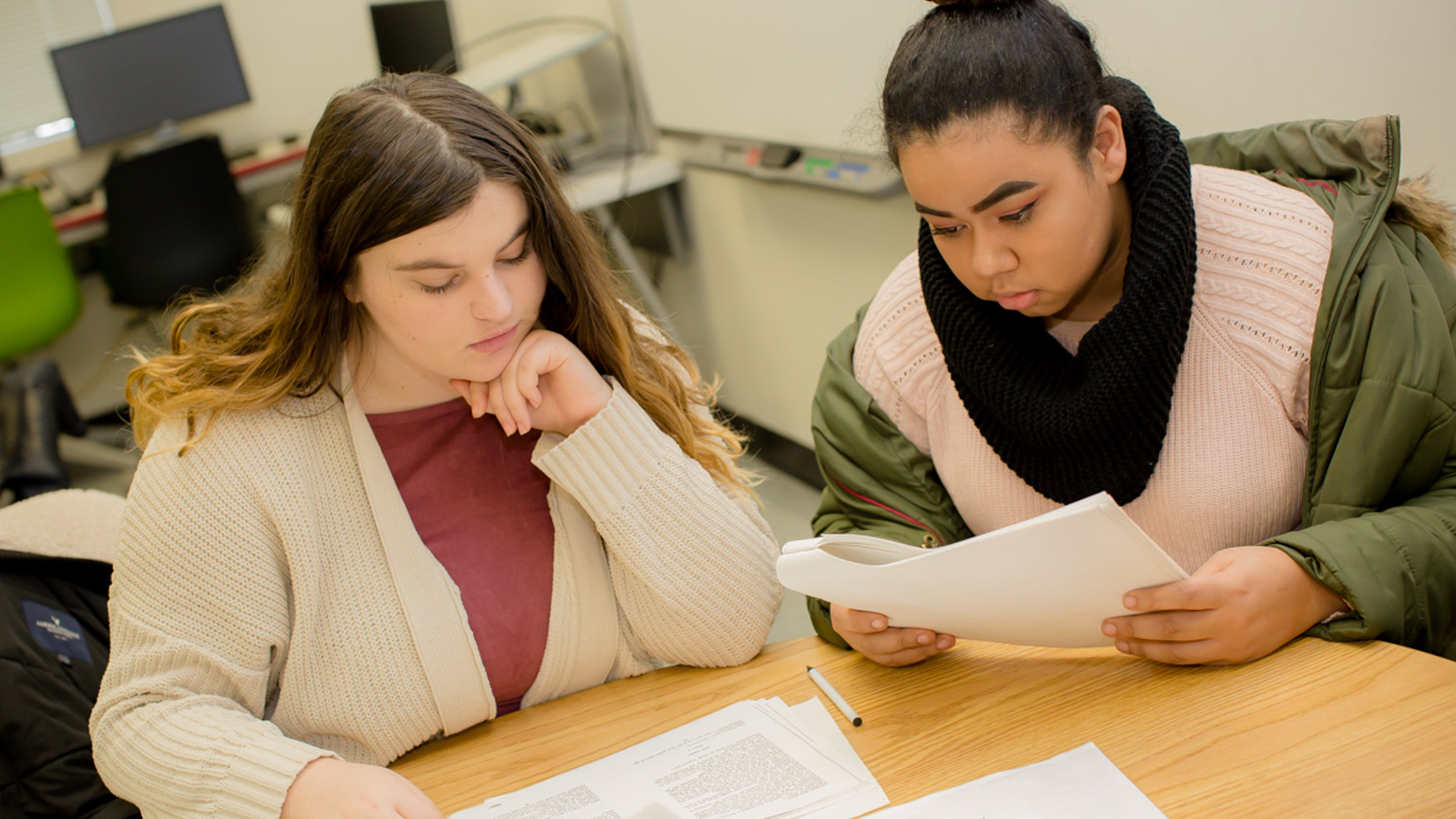 Two students reading project instructions together