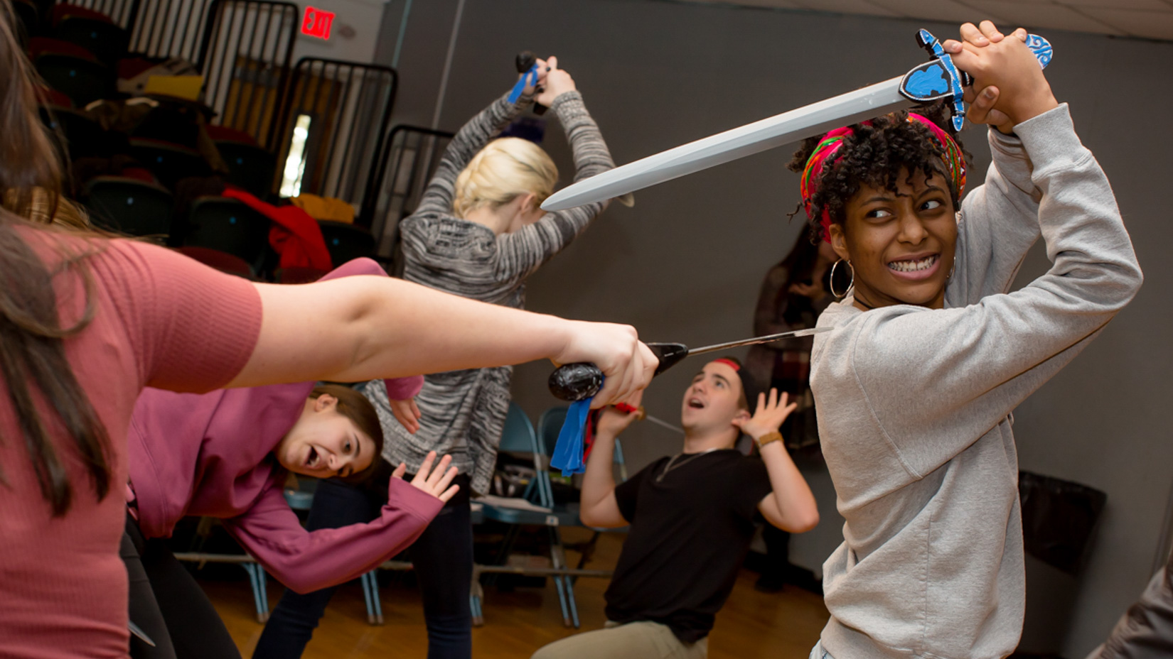 Students learning how to sword fight