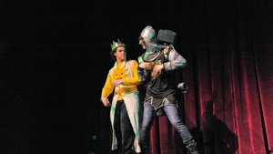 Two male students acting on stage during a performance