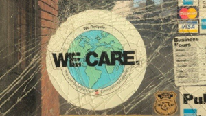 We Care sticker on a smashed piece of glass