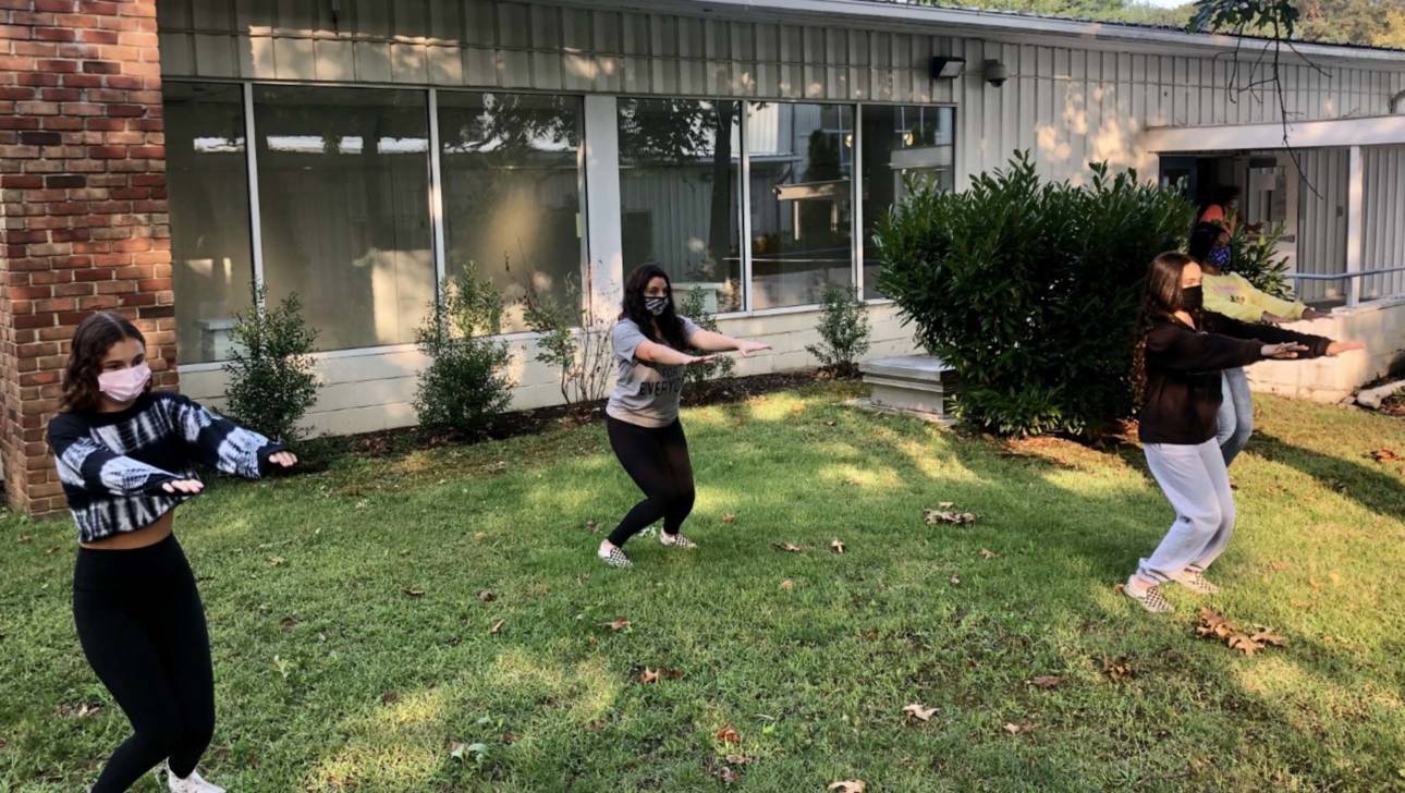 Performing Arts class students stretching outside