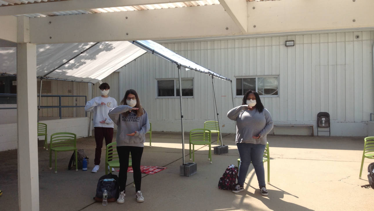 Performing Arts class singing warmup outside