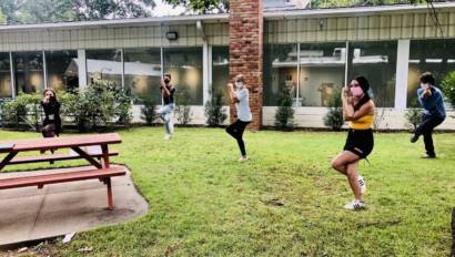 Performing Arts class students stretching outside