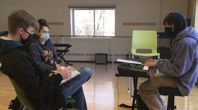 students in masks working on music