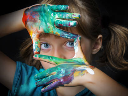 little girl with paint on hands