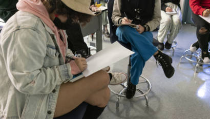 students sketching on paper during class